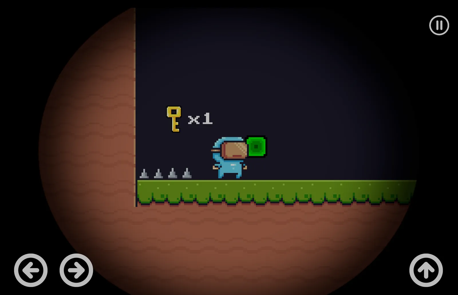 A dark underground level where the player stands next to a green switch block near a row of spikes, with a collected-keys counter reading "x1".